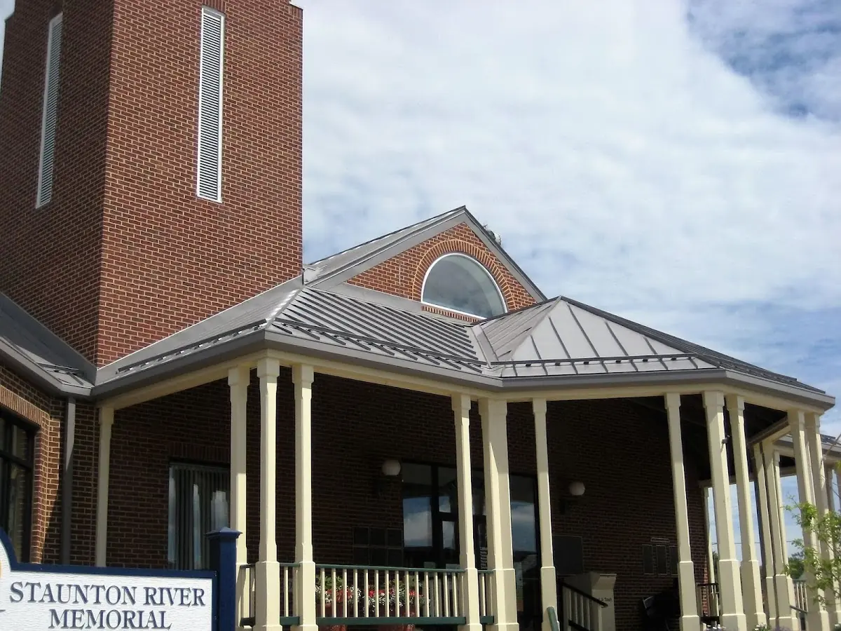 Skilled roofing craftsmen working on a residential roof in Adel